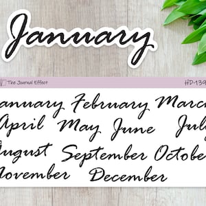 May include: A sheet of white sticker paper with black cursive text listing the months of the year. The text reads "January, February, March, April, May, June, July, August, September, October, November, December".
