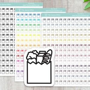 May include: A sheet of stickers with a variety of colored borders. The stickers are blank and can be used for journaling, planning, or other creative projects. The sheet also includes a single sticker with a black and white illustration of a grocery bag filled with groceries.