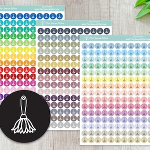 May include: Three sheets of colorful stickers with a broom and dustpan icon. The stickers are in various colors, including blue, green, yellow, orange, red, purple, brown, and gray. The stickers are arranged in rows and columns. The text "The Journal Effect" and a website address are printed on each sheet.