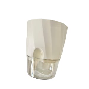 May include: White plastic self-watering planter with a clear reservoir and a wick system. The planter has a geometric design and is ideal for indoor plants.