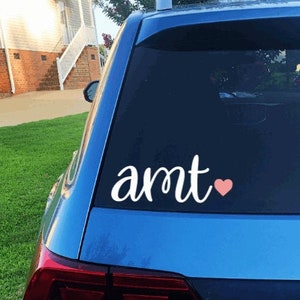 May include: A blue car with a white vinyl decal that says "amt" with a pink heart.