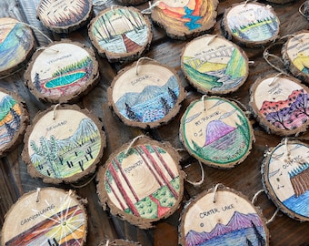 May include: A collection of 14 round wooden ornaments with hand-painted illustrations of various national parks. Each ornament features a different park name, such as Yellowstone, Glacier, and Mt. Rainier, along with a unique illustration of the park's landscape.