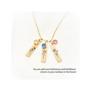 Gold birth flower necklace with personalized birthstone charms. Features engraved floral designs representing birth months. Additional charms can be added over time. A sentimental and elegant gift for mothers, grandmothers, or loved ones on special occasions.