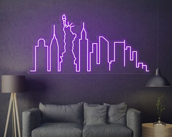 May include: Purple neon sign depicting the New York City skyline, including the Statue of Liberty, against a dark grey wall.