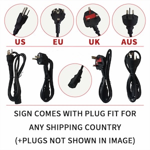 May include: Image showing various black power cords with different plug types labeled US, EU, UK, and AUS. The text reads: "SIGN COMES WITH PLUG FIT FOR ANY SHIPPING COUNTRY (+PLUGS NOT SHOWN IN IMAGE)"