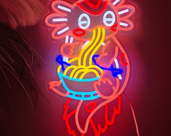 May include: A neon sign in the shape of an axolotl eating ramen noodles. The sign features a red, white, yellow, and blue color scheme. The axolotl is holding a bowl of noodles with chopsticks. The sign is lit up and has a red power cord.