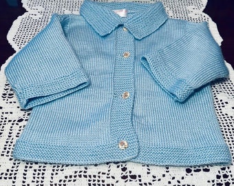 This Cardigan is a must have for your Baby. This baby sweater is hand knitted from wool and is blue color for baby boy or girl.