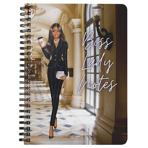 May include: Spiral-bound notebook with a cover featuring an illustration of a woman in a black suit holding a coffee cup and a purse. The words "Boss Lady Notes" are written in cursive. The background shows a hallway with columns and a patterned floor.