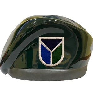 May include: A green beret with a white, blue, and green patch featuring a stylized Y shape.