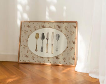 May include: A framed print with a beige background featuring a floral pattern. The print has a white oval in the center with five silver and gold utensils: a fork, a knife, two spoons, and a butter knife.