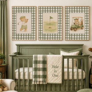May include: Three framed prints with a golf theme hang above a green crib. The prints feature a bear playing golf, a golf green with a flag, and a bear in a golf cart. The crib has a green and white checkered blanket and a cream quilt with "Hole in One" text.