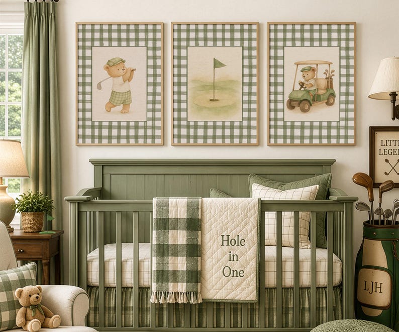May include: Three framed prints with a golf theme hang above a green crib. The prints feature a bear playing golf, a golf green with a flag, and a bear in a golf cart. The crib has a green and white checkered blanket and a cream quilt with "Hole in One" text.