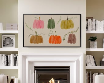 May include: A framed watercolor print featuring six pumpkins in shades of pink, green, yellow, brown, orange, and maroon. The pumpkins have green vines and are set against a beige background. The artwork is displayed above a fireplace.