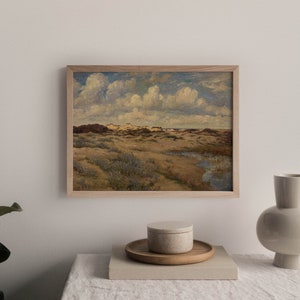 May include: A framed painting depicting a landscape with rolling hills, green grass, and a cloudy sky. The painting is in a wooden frame and is hanging on a white wall.