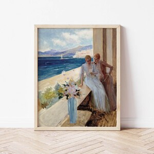 May include: A painting of two women in long dresses standing on a balcony overlooking a blue ocean and a city in the distance. The women are looking at each other and smiling. There are flowers in a blue vase on the balcony.