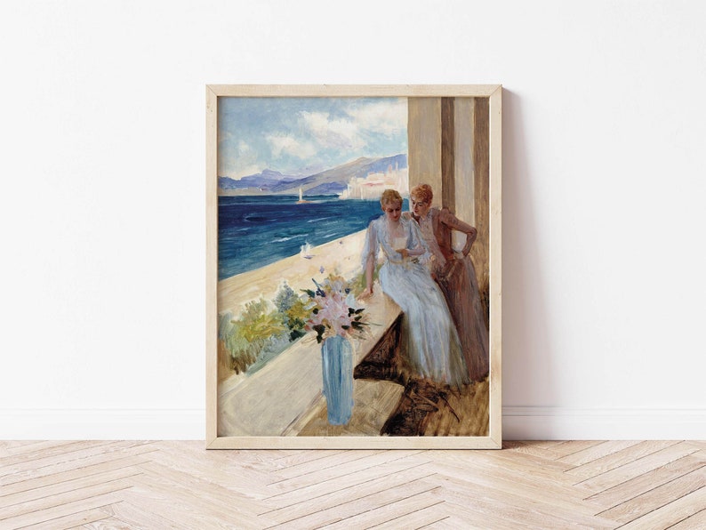 May include: A painting of two women in long dresses standing on a balcony overlooking a blue ocean and a city in the distance. The women are looking at each other and smiling. There are flowers in a blue vase on the balcony.