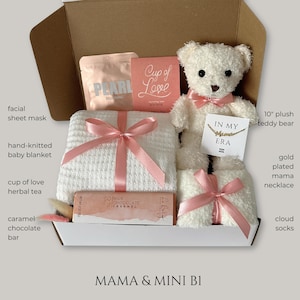 May include: A gift box filled with a 10" plush teddy bear, a hand-knitted baby blanket, cloud socks, a facial sheet mask, a caramel chocolate bar, and a gold-plated "Mama" necklace. The box also contains herbal tea and a card that says "Cup of Love".