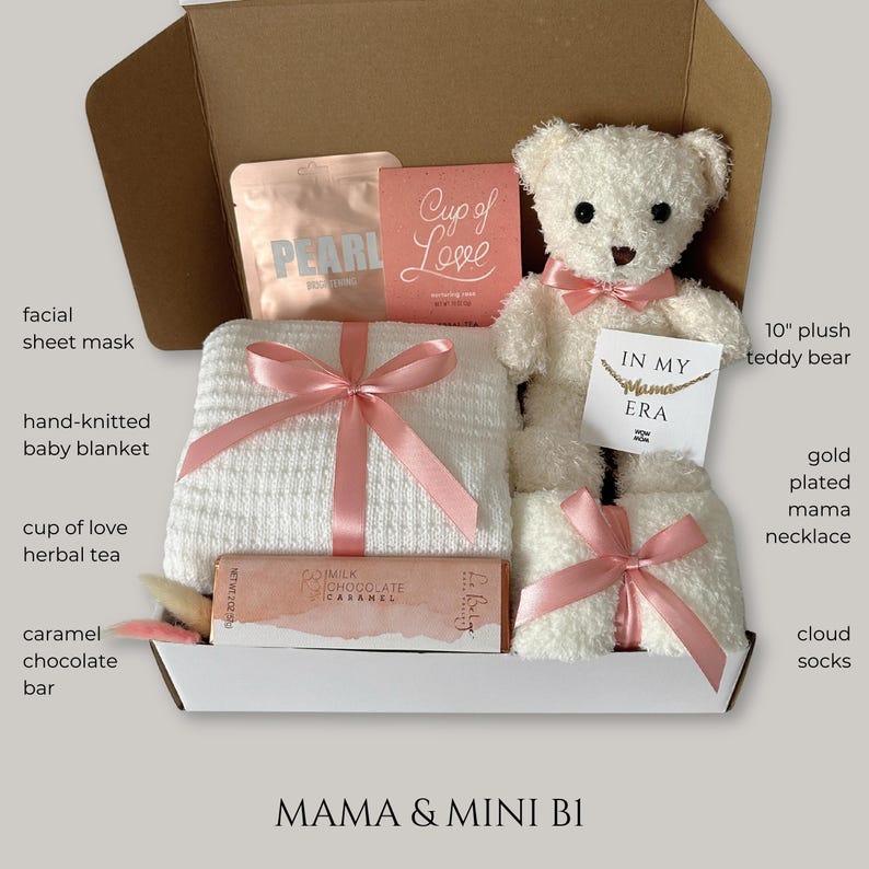 May include: A gift box filled with a 10" plush teddy bear, a hand-knitted baby blanket, cloud socks, a facial sheet mask, a caramel chocolate bar, and a gold-plated "Mama" necklace. The box also contains herbal tea and a card that says "Cup of Love".