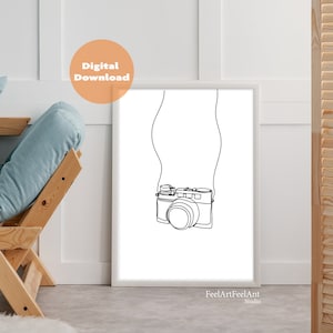 May include: A black and white line drawing of a camera with a strap hanging around its neck. The drawing is on a white background and framed in a white frame.