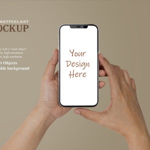 May include: A mockup of a smartphone being held in a person's hands. The phone has a white screen with the text "Your Design Here" written on it.