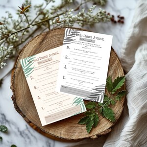 May include: Two printable prayer journal pages with a tropical leaf design. The pages include prompts for prayer requests, praise, and scripture.
