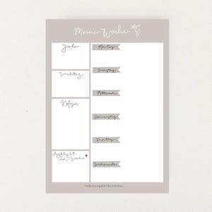 Pu&ograve; includere: Un planner settimanale stampabile con sfondo grigio chiaro e un design floreale. Il planner &egrave; diviso in sezioni per obiettivi, compiti importanti, note e compiti quotidiani. I giorni della settimana sono elencati in tedesco: Montag, Dienstag, Mittwoch, Donnerstag, Freitag, Wochenende.