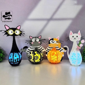 May include: Four cat-shaped decorative lamps. The first is black with glasses, the second is gray with a striped shirt, the third is orange and black with a scarf, and the fourth is white with flowers. Each cat holds a lantern.