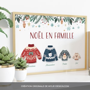 Peut inclure: Une impression encadrée blanche sur le thème de Noël. L'impression présente une guirlande verte avec des baies rouges et des étoiles dorées. Le texte "NOËL EN FAMILLE" est écrit en rouge. Quatre pulls de Noël colorés sont affichés sous le texte, chacun avec un design différent et un nom en dessous : "Christian", "Amandine", "Pablo" et "Zoé".