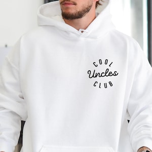 May include: White hoodie with a front pocket and a hood. The text "COOL Uncles CLUB" is printed in black on the upper left chest area. The word "WHITE" is printed in the lower left corner.