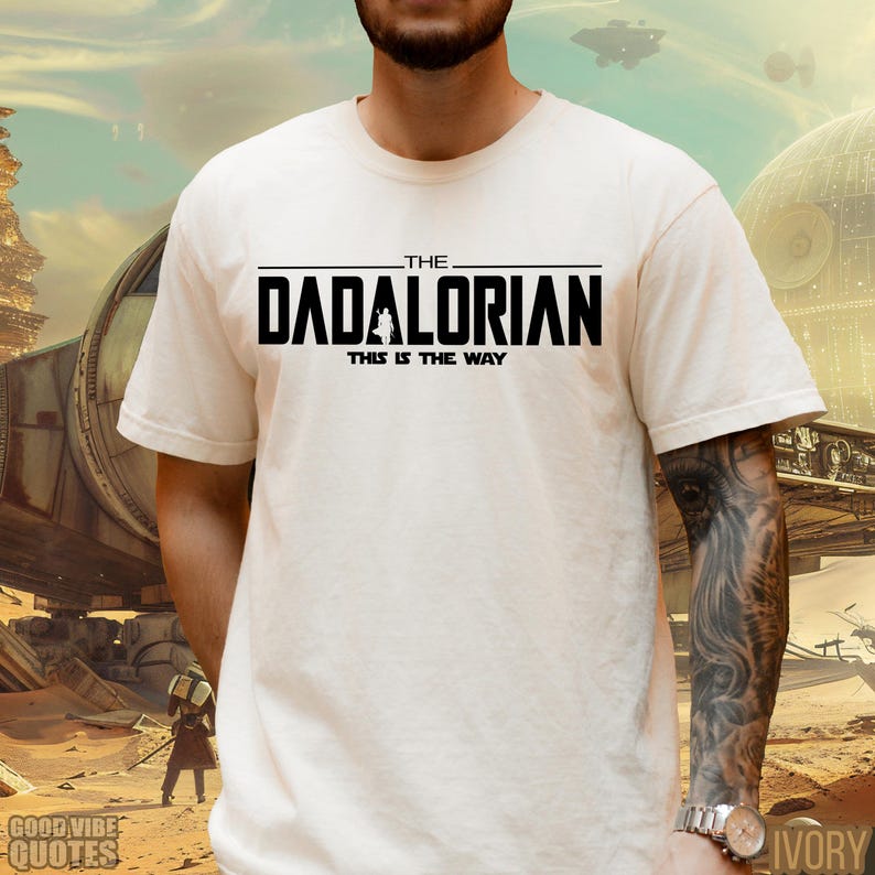May include: White t-shirt with black text that reads "The Dadalorian This is the Way".