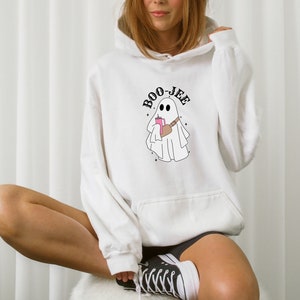 May include: White hoodie with a ghost graphic and the text "BOO-JEE" printed on the front.