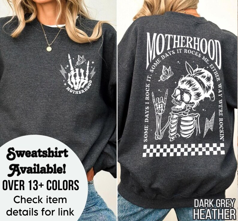 May include: Dark grey heather sweatshirt with a white graphic of a skeleton with a butterfly and the text "MOTHERHOOD SOME DAYS I ROCK IT. SOME DAYS IT ROCKS ME. EITHER WAY WE'RE ROCKIN'."