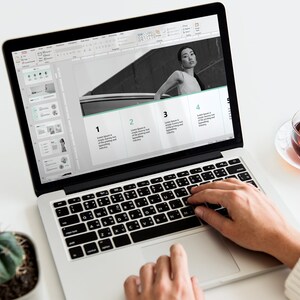 May include: A person working on a laptop computer with a presentation open on the screen. The presentation has four sections with numbers 1 through 4. The presentation includes a black and white photo of a person standing next to a car. The laptop is on a white desk with a cactus plant, a cup of tea, and a smartphone with the time 10:00 and the word "Monday" displayed.
