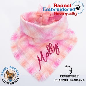 a pink and white scarf with a name on it