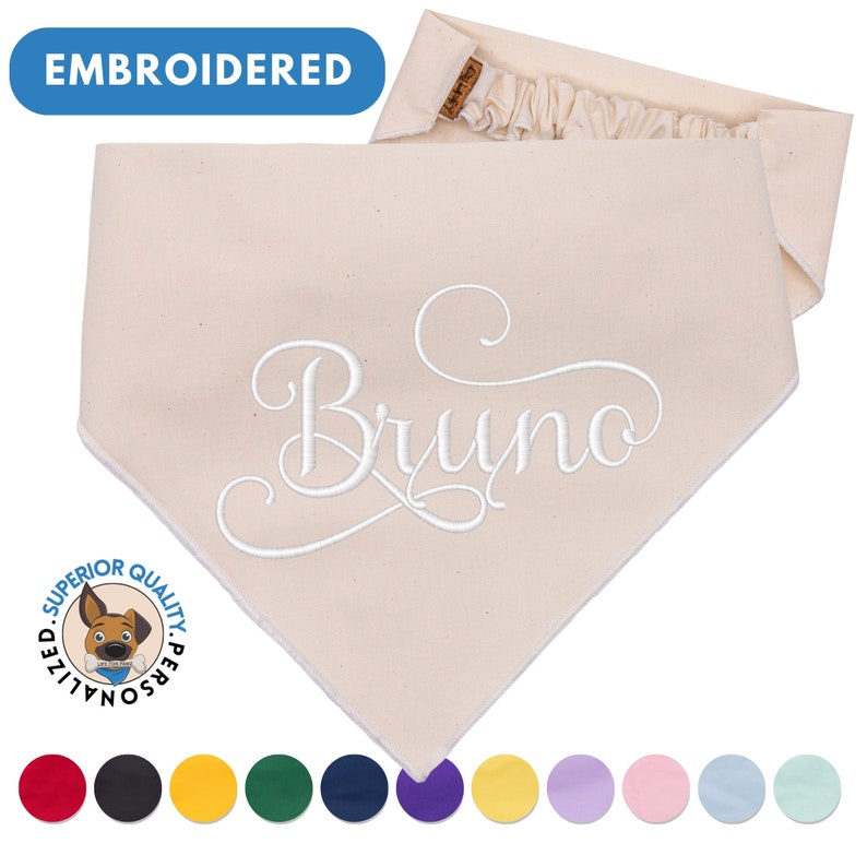 May include: Beige cotton dog bandana with the name "Bruno" embroidered in white. The bandana has a ruffled edge and is personalized with a dog logo. The image also shows a variety of color options for the bandana.