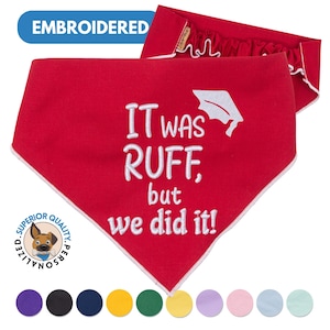 May include: Red dog bandana with white embroidery that reads "It was ruff, but we did it!" with a graduation cap graphic. The bandana is personalized with a dog silhouette and the words "Superior Quality Personalized".