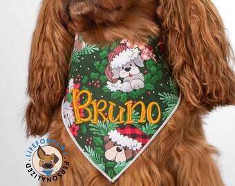May include: A personalized dog bandana with the name "Bruno" embroidered in gold. The green bandana features a Christmas-themed design with illustrations of dogs wearing Santa hats and holly leaves. The bandana is personalized with the dog's name.