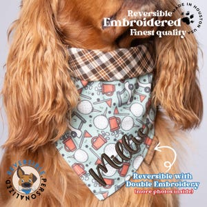 May include: A reversible dog bandana with a golf-themed print and the name "Millie" embroidered on it. The bandana is made in the USA and features a plaid pattern on the reverse side.