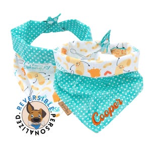 May include: A turquoise and white reversible dog bandana with a macaroni and cheese design. The bandana has the text "You're my forever" and "I love cheesy" on one side and the name "Cooper" on the other side.