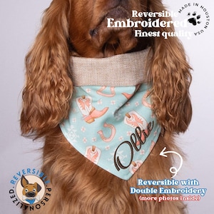May include: A light blue bandana with a white and pink cowboy boot pattern and a horseshoe design. The bandana is reversible with double embroidery and the name "Ollie" is embroidered on the bandana. The bandana is worn by a brown and white dog.