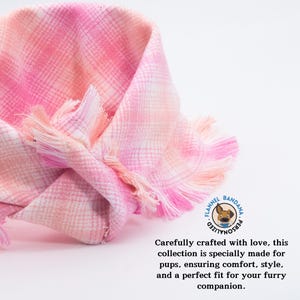a pink and white checkered scarf with a quote on it