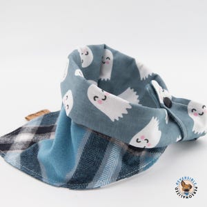 a blue and white scarf with ghost faces on it