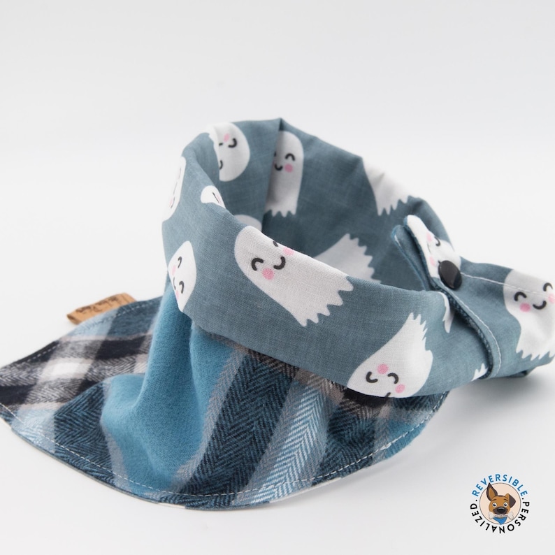 a blue and white scarf with ghost faces on it