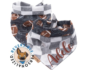 May include: Reversible personalised dog bandana with a black and white checked pattern on one side and a football pattern on the other side. The bandana is embroidered with the name "Adele".