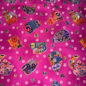 May include: Pink fabric featuring a repeating pattern of colourful, stylised cats. The cats are drawn in a whimsical style with intricate details and are surrounded by small white swirls.