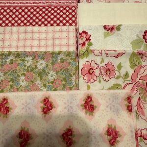 May include: A collection of fabric squares in various patterns, including red and white gingham, floral prints, and a pink and white geometric design.
