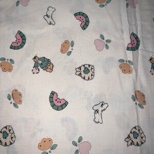 May include: White fabric with a repeating pattern of watermelon slices, cats, dogs, and hearts. The pattern is in shades of pink, green, and brown.