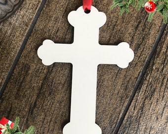 May include: White wooden cross ornament with a red ribbon attached. The ornament is blank and ready to be personalized.