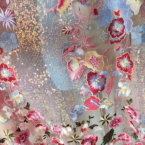 May include: Pink sheer fabric with iridescent sequins and embroidered floral designs in shades of pink, blue, yellow, and red.