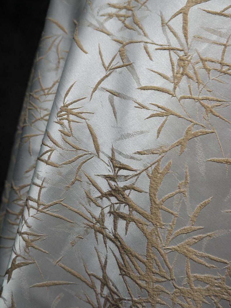May include: White fabric with a raised embossed pattern of brown bamboo branches.